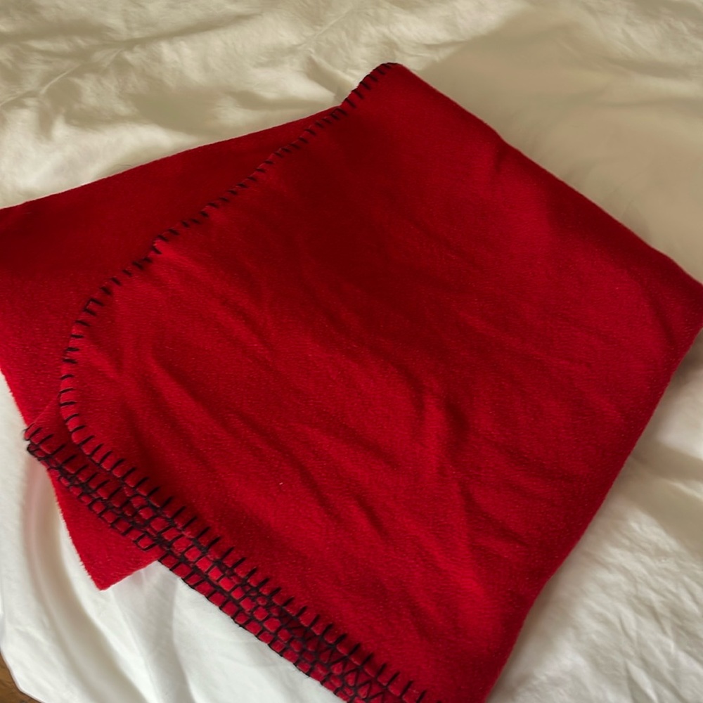 Red fleece blanket with black trim. In very good to great condition. Twin size.